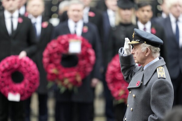 Britain's King Charles III salutes as he attends the Remembrance Sunday ceremony at the Cenotaph on Whitehall in London, Sunday, Nov. 12, 2023. Every year, members of the British Royal family join politicians, veterans and members of the public to remember those who have died in combat. (AP Photo/Kin Cheung, Pool)