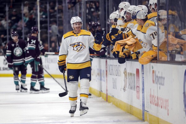 Nashville Predators center Gustav Nyquist (14) celebrates with his team after scoring during the third period of an NHL hockey game against the Anaheim Ducks, Sunday, Feb. 25, 2024, in Anaheim, Calif. (AP Photo/Yannick Peterhans)