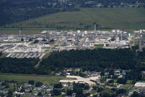 FILE - The Fifth Ward Elementary School and residential neighborhoods sit near the Denka Performance Elastomer Plant, back, in Reserve, La., Sept. 23, 2022. In what could prove a significant move for communities facing air pollution, the Environmental Protection Agency proposed on Thursday, April 6, 2023, that chemical plants nationwide measure certain hazardous compounds that cross beyond their property lines and reduce them when they are too high. (AP Photo/Gerald Herbert, File)