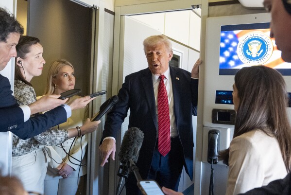 President Donald Trump speaks to reporters aboard Air Force One en route from Riyadh, Saudi Arabia to Doha, Qatar, Wednesday, May 14, 2025. (AP Photo/Alex Brandon)