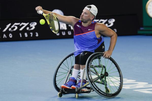 FILE - Dylan Alcott of Australia plays a backhand to Sam Schroder of the Netherlands in the final of the quad wheelchair singles final at the Australian Open tennis championships in Melbourne, Australia, Jan. 27, 2022. Australian Prime Minister Anthony Albanese said on Tuesday his official delegation to Queen Elizabeth II's funeral next week will include racehorse trainer Chris Waller and wheelchair tennis star Alcott. (AP Photo/Simon Baker, FILE)