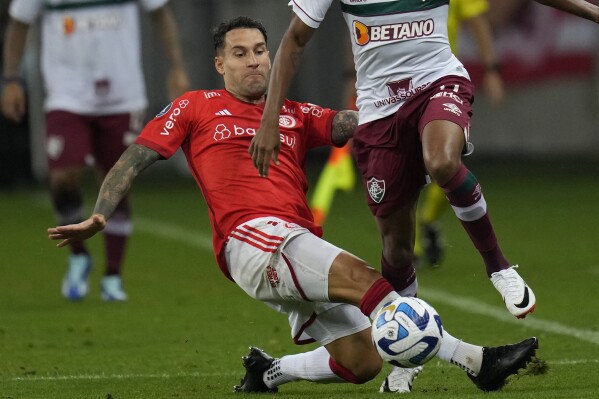 Hugo Mallo of Brazil's Internacional battles for the ball during a Copa Libertadores semifinal second leg soccer match at Beira Rio stadium in Porto Alegre, Brazil, Wednesday, Oct. 4, 2023. Soccer player Hugo Mallo will go on trial on an accusation he inappropriately touched a mascot before a Spanish league game in 2019, court officials said Wednesday. Mallo, who denies wrongdoing, was with Celta Vigo when the alleged incident happened before a first-division match against Espanyol. The 32-year-old Spanish player currently plays for Brazilian club Internacional. (AP Photo/Andre Penner)