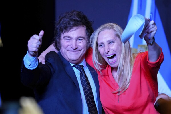 Presidential candidate Javier Milei, right, celebrates with his sister Karina Milei during his victory speech after winning a presidential runoff election in Buenos Aires, Argentina, Sunday, Nov. 19, 2023. (AP Photo/Natacha Pisarenko)