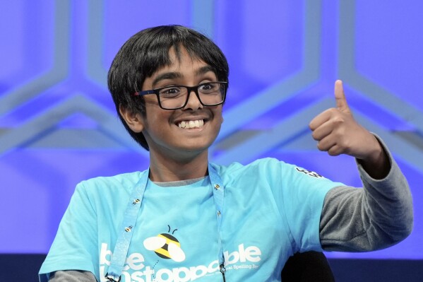 Faizan Zaki, 12, of Allen, Texas, gestured to his family after correctly spelling his words in the final of Oxon Hill, Mariam Zhive, File, Oxon Hill, Maryland on May 30, 2024 at Scripps National Spell Bee.