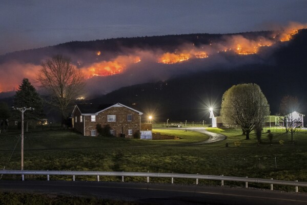 A wildfire burns along the western slope of Massanutten Mountain near New Market, Va., Friday, March 22, 2024. (Daniel Lin/Daily News-Record via AP)