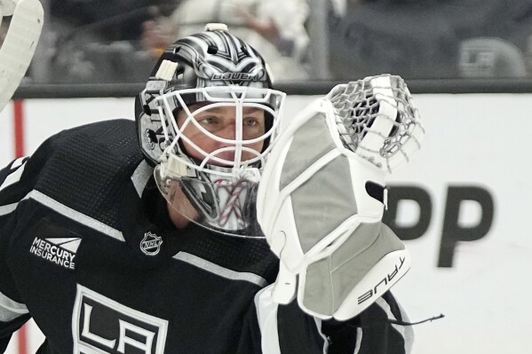 Los Angeles Kings goaltender Pheonix Copley makes a glove save during the first period of an NHL hockey game against the Pittsburgh Penguins Thursday, Nov. 9, 2023, in Los Angeles. (AP Photo/Mark J. Terrill)