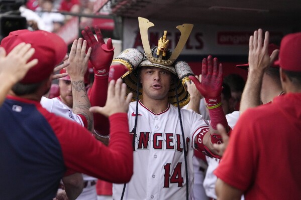Los Angeles Angels' Logan O'Hoppe is congratulated by teammates in the dugout after hitting a two-run home run during the first inning of a baseball game against the Cleveland Guardians Saturday, Sept. 9, 2023, in Anaheim, Calif. (AP Photo/Mark J. Terrill)