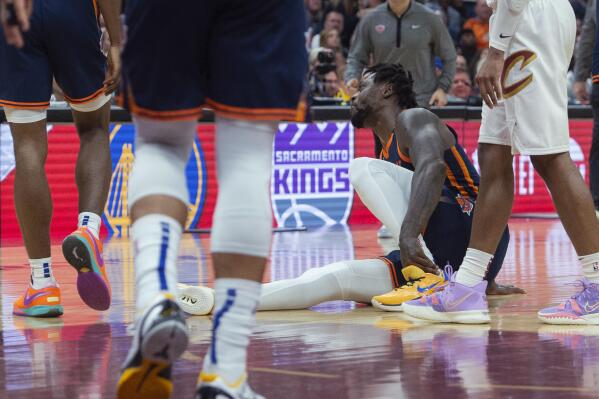 New York Knicks' Julius Randle (30) grabs his ankle during the first half of Game 5 of the team's NBA basketball first-round playoff series against the Cleveland Cavaliers, Wednesday, April 26, 2023, in Cleveland. (AP Photo/Phil Long)