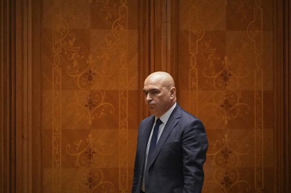 Romanian Prime Minister designate Ilie Bolojan arrives for a joint parliament session ahead of a vote of confidence for the new government team in Bucharest, Romania, Monday, June 23, 2025. (AP Photo/Andreea Alexandru)
