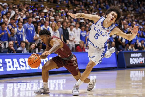 Duke's Tyrese Proctor (5) falls as Maryland-Eastern Shore's Glen Anderson (15) drives during the first half of an NCAA college basketball game in Durham, N.C., Saturday, Dec. 10, 2022. (AP Photo/Ben McKeown)