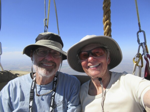 This 2019 image provided by Barbara Fricke shows Fricke and Peter Cuneo in a balloon basket. It's been 15 years since the world's elite gas balloon pilots have gathered in the United States for the Coupe Gordon Bennett, a long-distance race whose roots stretch back more than a century. Fricke and Cuneo will be participating in the 2023 Gordon Bennett competition. The flight window opens Saturday, Oct. 7. (Barbara Fricke via AP)