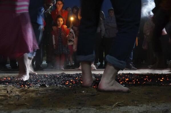 Firewalkers dance across a bed of burning coals in a ritual in honor of St. Constantine in the village of Lagkadas, Greece on Monday, May 22, 2023. Firewalking is the most spectacular and public of these annual rituals that also include dancing with icons, prayer, and shared meals by associations of devotees of the Christian Orthodox saint called "anastenaria" that have held similar celebrations for centuries. (AP Photo/Giovanna Dell'Orto)