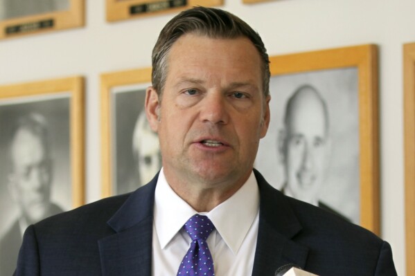 FILE - Kansas Attorney General Kris Kobach answers questions from reporters during a news conference outside his office, May 1, 2023, in Topeka, Kan. The Kansas judge ruled Monday, March 11, 2024 that the state isn't violating rights granted to transgender residents under the state constitution by refusing to change their driver's licenses to reflect their gender identity. (AP Photo/John Hanna, File)