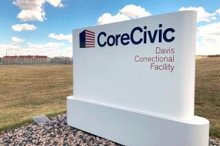The Davis Correctional Facility, a private prison in Holdenville, Oklahoma, operated by Tennessee-based CoreCivic, is shown on Sept. 20, 2022. The 1,700-bed men’s prison where a correctional officer was fatally stabbed this summer has struggled to hire and retain staff and was operating at about 70% of its contractually obligated staffing level, according to a 2021 audit of the facility. (AP Photo/Sean Murphy)