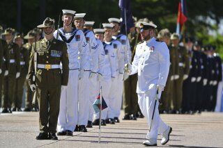 An honor guard is formed at Defence Headquarters in Canberra, Australia, Thursday, Nov. 19, 2020, before findings from the Inspector-General of the Australian Defence Force Afghanistan Inquiry are released. A shocking report into war crimes by elite Australian troops has found evidence that 25 soldiers unlawfully killed 39 Afghan prisoners, farmers and civilians. (Mick Tsikas/AAP Image via AP)