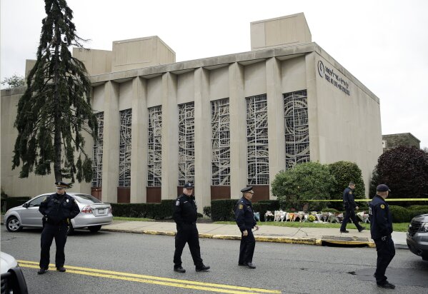 
              Law enforcement are position outside the Tree of Life Synagogue in Pittsburgh, Sunday, Oct. 28, 2018. Robert Bowers, the suspect in the mass shooting at the synagogue, expressed hatred of Jews during the rampage and told officers afterward that Jews were committing genocide and he wanted them all to die, according to charging documents made public Sunday.(AP Photo/Matt Rourke)
            