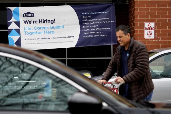 A hiring sign is displayed at a home improvement store in Northbrook, Ill., Thursday, May 5, 2022.  America’s employers added 428,000 jobs in April, extending a streak of solid hiring that has defied punishing inflation, chronic supply shortages, the Russian war against Ukraine and much higher borrowing costs.  (AP Photo/Nam Y. Huh)