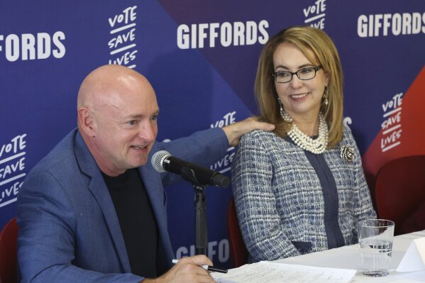 
              FILE- In this Oct. 2, 2018, file photo retired NASA astronaut and Navy Capt. Mark Kelly speaks as his wife, former U.S. Rep. Gabby Giffords looks on during a roundtable discussion with gun violence survivors, at UNLV in Las Vegas. Kelly said Tuesday, Feb. 12, 2019, that he's running to finish John McCain's term in the U.S. Senate. (Bizuayehu Tesfaye/Las Vegas Review-Journal via AP, File)
            