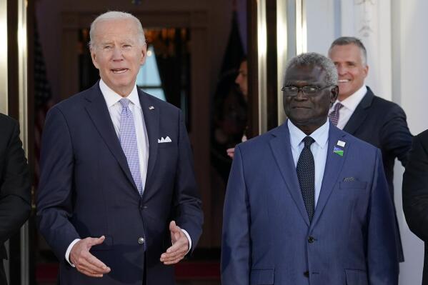 FILE - President Joe Biden speaks as he poses for photos with Pacific Island leaders, including Solomon Islands Prime Minister Manasseh Sogavare, right, on the North Portico of the White House in Washington, Thursday, Sept. 29, 2022. The Biden administration is plowing ahead with plans to re-open the U.S. embassy in the Solomon Islands in a bid to counter China’s increasing assertiveness in the Pacific. (AP Photo/Susan Walsh, File)