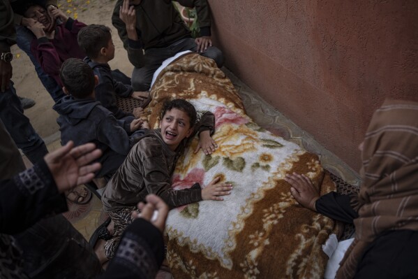 Palestinians mourn their relatives killed in the Israeli bombardment of the Gaza Strip, in the hospital in Khan Younis, Saturday, Nov. 11, 2023. (AP Photo/Fatima Shbair)