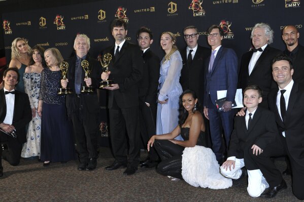 
              The cast and crew of "The Young and the Restless" pose in the press room with the award for outstanding drama series at the 46th annual Daytime Emmy Awards at the Pasadena Civic Center on Sunday, May 5, 2019, in Pasadena, Calif. (Photo by Richard Shotwell/Invision/AP)
            