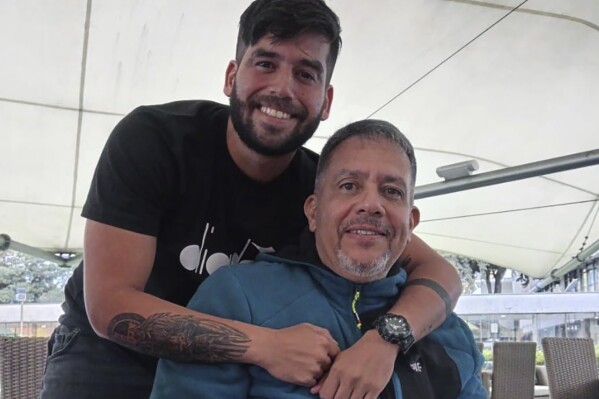 In this 2023 photo provided by Maria Elena Machado, Lt. Pedro Naranjo , appears with his father, retired Gen. Pedro Naranjo in Colombia. The son of a prominent opponent of Venezuela’s Nicolas Maduro has been arrested after being deported by the U.S. in what migration experts say was a perfectly foreseeable outcome of the Biden administration’s push to discourage asylum seekers from the turbulent South American nation. Retired Gen. Pedro Naranjo, in an interview from a migration detention center in Texas, said his son—like him a helicopter pilot in Venezuela’s Air Force—played no role in the 2018 barracks conspiracy for which he spent more than three years in jail. ( Maria Elena Machado via AP)