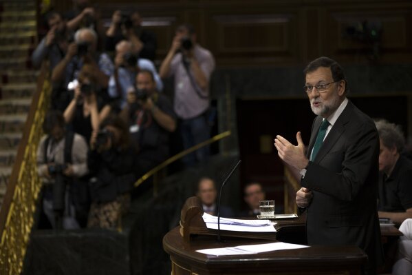 
              Spain's Prime Minister Mariano Rajoy and Popular Party leader addresses lawmakers during the first day of a motion of no confidence session at the Spanish parliament in Madrid, Thursday, May 31, 2018. The lower house of the Spanish parliament is debating whether to end Prime Minister Mariano Rajoy's close to eight years in power and supplant him with the leader of the Socialist opposition. (AP Photo/Francisco Seco)
            