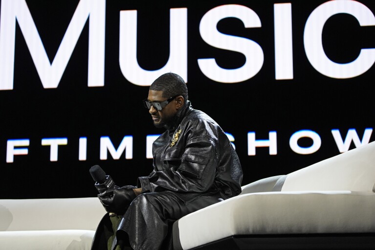 Usher listens during a news conference ahead of the Super Bowl 58 NFL football game Thursday, Feb. 8, 2024, in Las Vegas. Usher will perform during the Super Bowl halftime show. (AP Photo/John Locher)