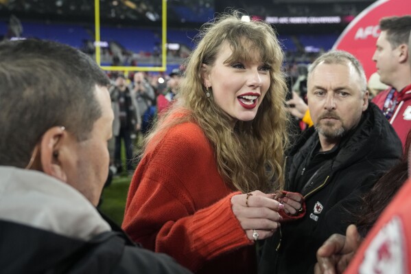 Taylor Swift speaks with people on the field after an AFC Championship NFL football game between the Baltimore Ravens and the Kansas City Chiefs, Sunday, Jan. 28, 2024, in Baltimore. The Kansas City Chiefs won 17-10. (APPhoto/Alex Brandon)
