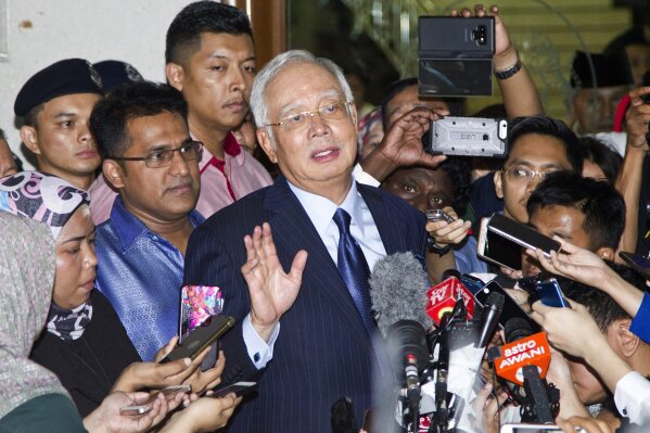 FILE - In this Sept. 20, 2018, file photo, former Prime Minister Najib Razak, center, speaks during a press conference after a court hearing at Kuala Lumpur High Court in Kuala Lumpur, Malaysia. Na...