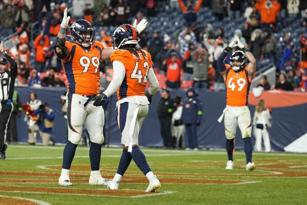 Denver Broncos defensive end Zach Allen (99) is congratulated by teammates Nik Bonitto (42) and Alex Singleton (49)after sacking Cleveland Browns quarterback PJ Walker in the end zone for a safety during the second half of an NFL football game on Sunday, Nov. 26, 2023, in Denver. (AP Photo/Jack Dempsey)