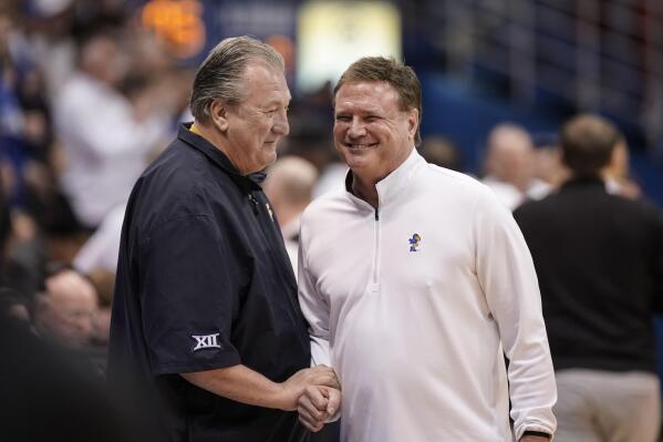 West Virginia head coach Bob Huggins, left, and Kansas head coach Bill Self have a laugh before tipoff of an NCAA college basketball game on Saturday, Feb. 25, 2023, at Allen Fieldhouse in Lawrence, Kan. (AP Photo/Nick Krug)