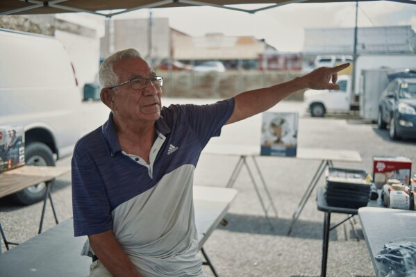 George Rodriguez, a 72-year-old lifelong resident of Eagle Pass, sells goods at a flea market near Shelby Park in Eagle Pass, Texas, on Friday, Aug. 9, 2024. (Jordan Vonderhaar/The Texas Tribune via AP)