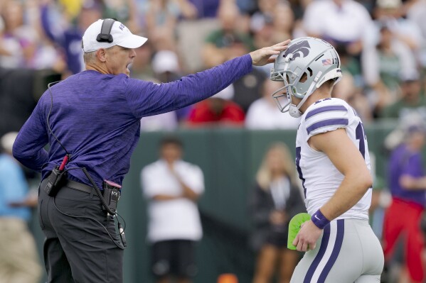 Kansas State head coach Chris Klieman celebrates a kick by Kansas State kicker Chris Tennant (17) during the first half of an NCAA college football game against Tuland in New Orleans, Saturday, Sept. 7, 2024. (AP Photo/Matthew Hinton)