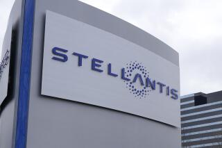 FILE - A Stellantis sign is seen outside the Chrysler Technology Center, Jan. 19, 2021, in Auburn Hills, Mich. Stellantis has warned of a potential existential threat to large parts of the British car industry unless the government moves to alter the terms of its Brexit trade deal with the European Union. In a submission to a parliamentary inquiry into the supply of batteries for electric vehicles released Wednesday, May 17, 2023, the parent company of Citroen, Fiat, Peugeot and Vauxhall said it may not be able to keep its commitment to manufacture its new fleet of cars in the U.K. without changes to the terms of the deal. (AP Photo/Carlos Osorio, File)