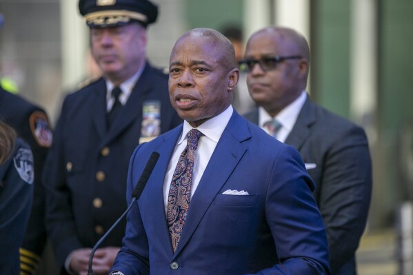 FILE - New York City Mayor Eric Adams speaks in New York's Times Square during a news conference, Dec. 30, 2022. Adams has been using artificial intelligence to make robocalls that contort his own voice into several languages he doesn't actually speak, posing new ethical questions about the government's use of the rapidly evolving technology. The mayor told reporters about the robocalls on Monday, Oct. 17, 2023, and said they've went out in languages such as Mandarin and Yiddish to promote city hiring events. (AP Photo/Ted Shaffrey, File)