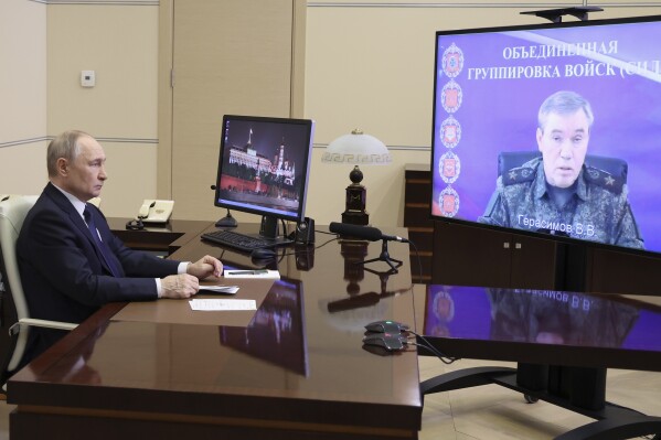 Russian President Vladimir Putin listens to Russian Chief of General Staff Gen. Valery Gerasimov with the report that all Ukrainian troops have been forced from Russia's Kursk region, during their meeting via videoconference at the Novo-Ogaryovo residence outside Moscow, Russia, Saturday, April 26, 2025. (Alexander Kazakov, Sputnik, Kremlin Pool Photo via AP)