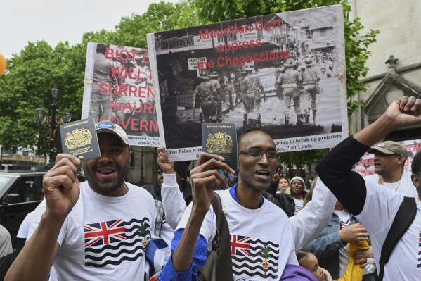 People demonstrate outside the High Court in London, Thursday, May 22, 2025, after a British court blocked the U.K. from transferring sovereignty over the Chagos Islands to Mauritius hours before the agreement was due to be signed. (AP Photo/Thomas Krych)