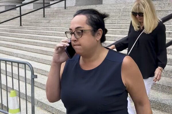 Peaches Stergo, left, leaves Manhattan federal court, Thursday, July 27, 2023, in New York after she was sentenced to more than four years in prison for cheating an 87-year-old Holocaust survivor of $2.8 million. Stergo met him on a dating website seven years ago. Prosecutors say the 36-year-old Champions Gate, Florida, resident used the money to live lavishly. (AP Photo/Larry Neumeister)