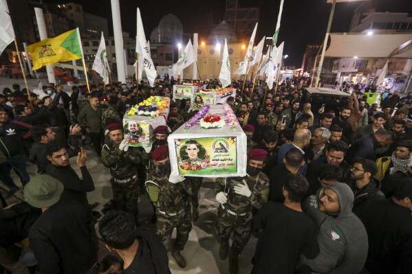 Iraqis attend the funeral of the Kataib Hezbollah members in Najaf, Iraq, Wednesday, Nov 22, 2023. Kataib Hezbollah fighters were killed in the US airstrikes in response to attacks against U.S. forces at Al-Asad Air Base earlier this week. (AP Photo/Anmar Khalil)