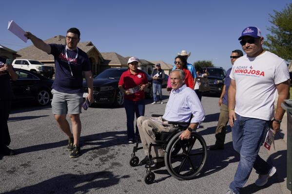 Texas Gov. Greg Abbott, center, canvasses for votes with volunteers and other republican candidates, Saturday, Oct. 1, 2022, in Harlingen, Texas. As Democrats embark on another October blitz in pursuit of flipping America's biggest red state, Republicans are taking a swing of their own: Making a play for the mostly Hispanic southern border on Nov. 8 after years of writing off the region that is overwhelmingly controlled by Democrats. (AP Photo/Eric Gay)
