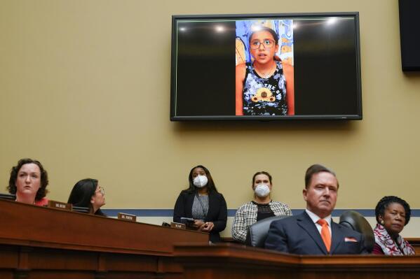 Miah Cerrillo, a fourth grade student at Robb Elementary School in Uvalde, Texas, and survivor of the mass shooting appears on a screen during a House Committee on Oversight and Reform hearing on gun violence on Capitol Hill in Washington, Wednesday, June 8, 2022. (AP Photo/Andrew Harnik, Pool)