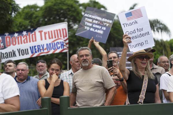 White South Africans demonstrate in support of U.S. President Donald Trump in front of the U.S. embassy in Pretoria, South Africa, Feb. 15, 2025. (AP Photo/Jerome Delay, File)