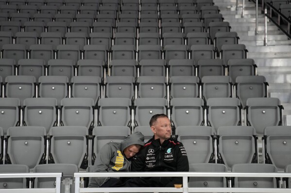 Fans wait around during a delay before the second practice session for the Formula One Las Vegas Grand Prix auto race, Thursday, Nov. 16, 2023, in Las Vegas. (AP Photo/John Locher)