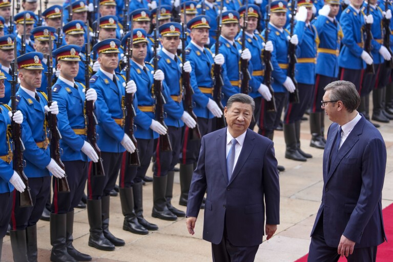 FILE - Chinese President Xi Jinping, left, reviews an honor guard with his Serbian counterpart Aleksandar Vucic during a welcome ceremony at the Serbia Palace in Belgrade, Serbia, Wednesday, May 8, 2024. Most countries in the European Union are making efforts to “de-risk” their economies from perceived threats posed by China. But Hungary and Serbia have gone in the other direction. They are courting major Chinese investments in the belief that the world’s second-largest economy is essential for Europe’s future. (AP Photo/Darko Vojinovic, File)