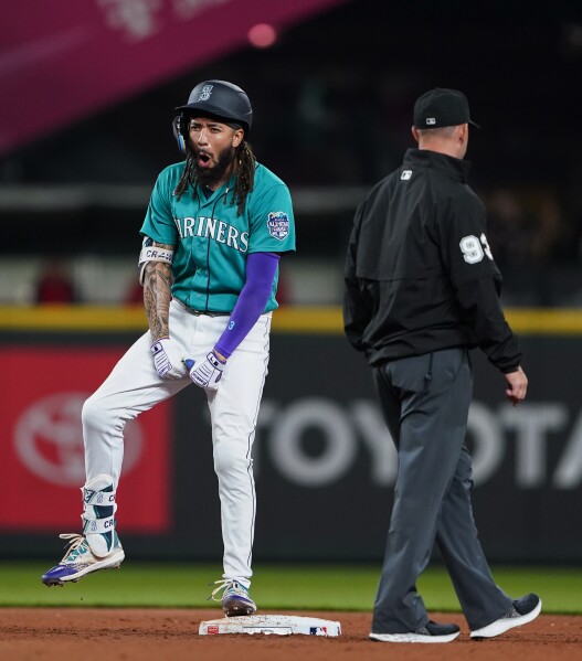 Seattle Mariners' J.P. Crawford reacts after grounding out with runners on  first and second to end the top of the eighth inning of the team's baseball  game against the Oakland Athletics in
