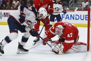 Columbus Blue Jackets center Boone Jenner (38) has his attempt to score stopped by Detroit Red Wings goaltender James Reimer (47) during the second period of an NHL hockey game Tuesday, March 19, 2024, in Detroit. (AP Photo/Duane Burleson)