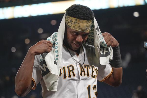 Pittsburgh Pirates' Ke'Bryan Hayes wipes his head after being doused by teammates after he drove in the winning run in the team's baseball game against the Washington Nationals, Friday, Sept. 10, 2021, in Pittsburgh. The Pirates won 4-3. (AP Photo/Keith Srakocic)