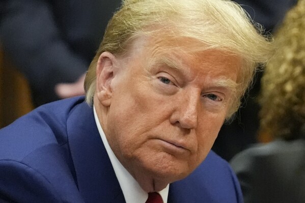 FILE - Former President Donald Trump awaits the start of a pre-trial hearing with his defense team at Manhattan criminal court, Monday, March 25, 2024, in New York. A dozen Manhattan residents are soon to become the first Americans ever to sit in judgment of a former president charged with a crime. Jury selection is set to start Monday in former President Donald Trump's hush-money trial. (AP Photo/Mary Altaffer, Pool)