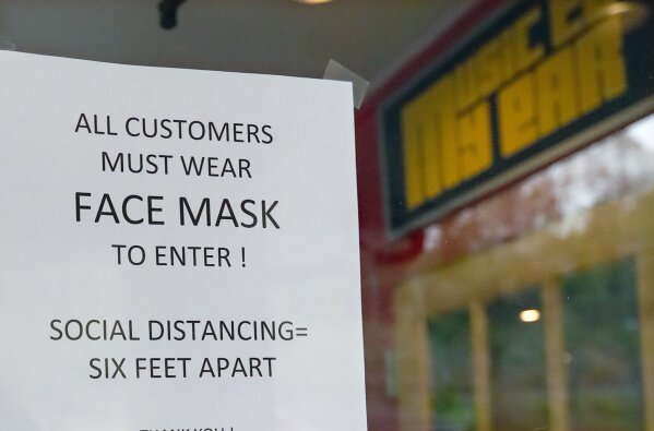 A sign tells customers the protocol to enter the "Music to My Ears" record and HiFi store, Thursday, May 14, 2020, in Pittsburgh, as he prepares to re-open Friday when some of the COVID-19 restrictions will be lessened in the city and several western Pennsylvania counties as they move from red to yellow status. (AP Photo/Keith Srakocic)